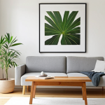 **

A brightly lit, minimalist living room with white walls, a light wood floor, and a simple grey sofa. A single, framed piece of abstract art hangs on the wall. A green plant sits on a low wooden table. Focus on clean lines and a sense of calm. Style: Muji-inspired, natural light, high-resolution photography.

**
